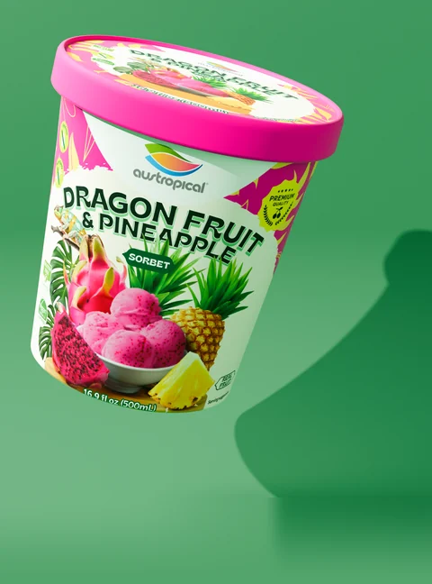 Austropical Dragon Fruit & Pineapple closed pint with its lid visible, on a colored background with a curved shadow
