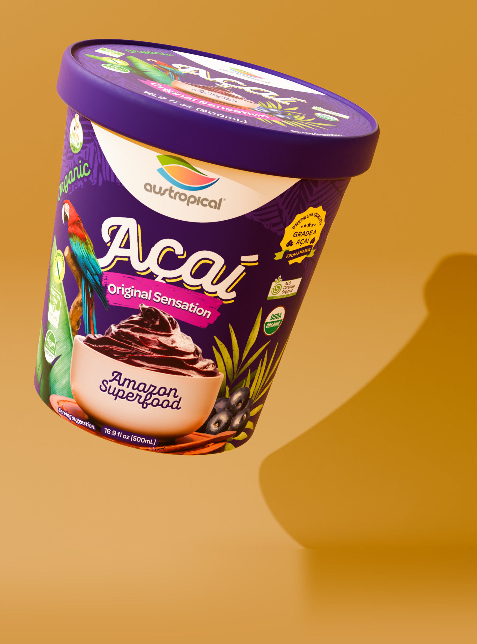 Austropical Organic Açaí Original Sensation sorbet pint floating on a mustard background, its shadow cast on the wall behind it.