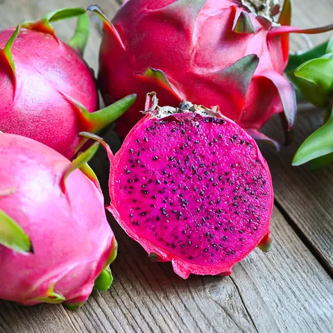 Dragon fruit cut open, showing the hot-pink flesh