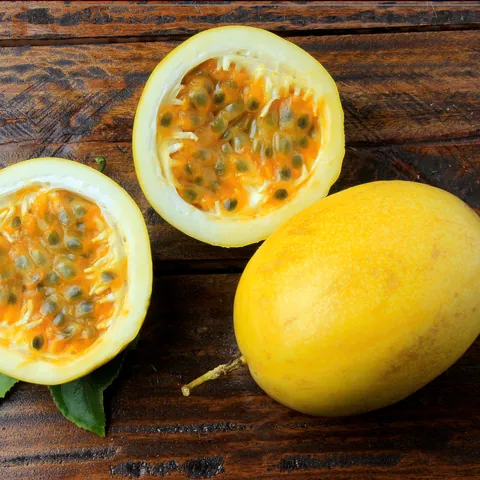 Passion fruit cut in half, showing the pulp and seeds